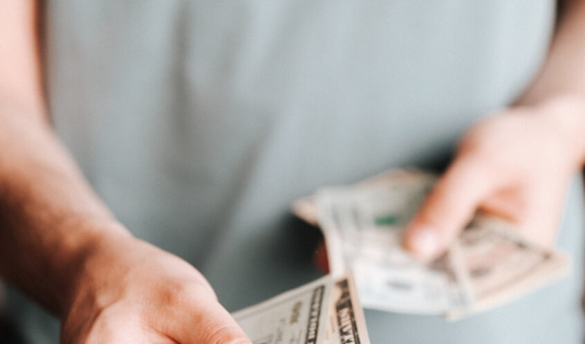 Free Crop man paying with American dollars Stock Photo