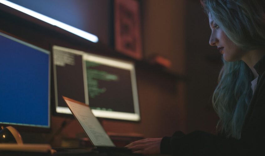 Free Side View of a Woman Using a Laptop Stock Photo