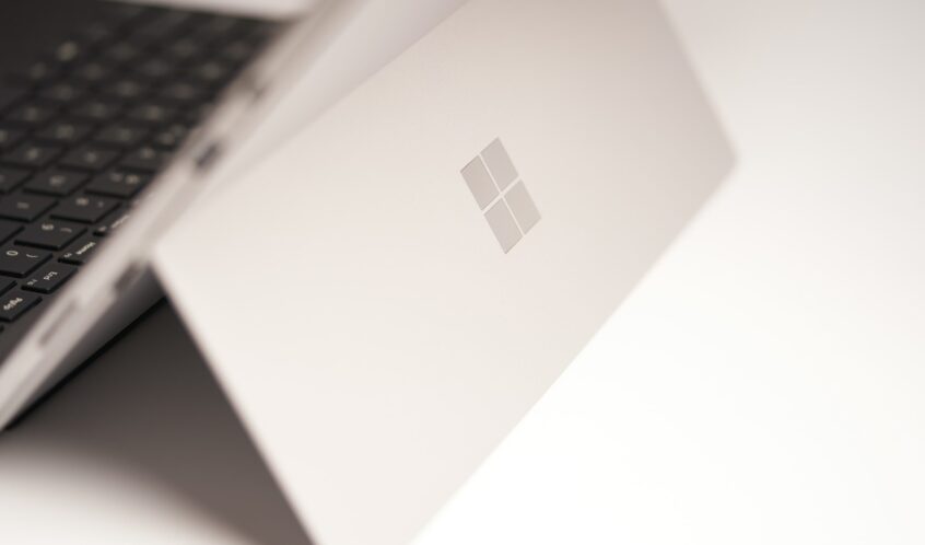 white laptop computer on white table