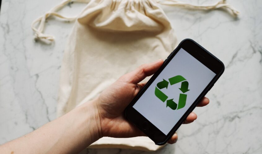 Free Faceless person showing recycle symbol on mobile phone screen Stock Photo