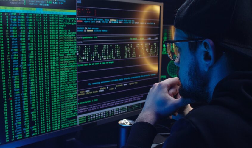 Free A Man Looking at a Computer Screen with Data Stock Photo