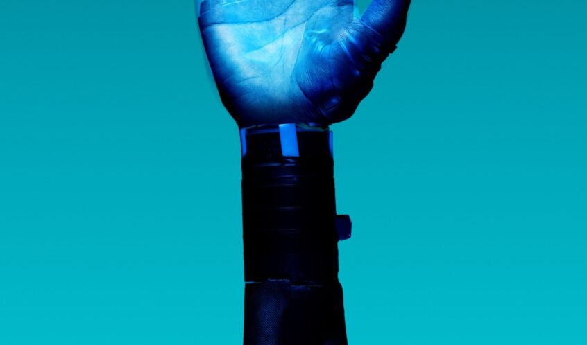alt="Free Prosthetic Arm on Blue Background Stock Photo"