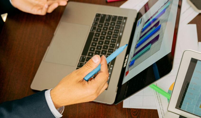 Free A Person in Black Suit Holding a Pen Stock Photo