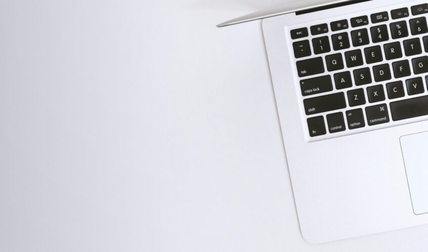 Free Aerial view of a sleek laptop keyboard on a clean, white surface, ideal for tech backgrounds. Stock Photo